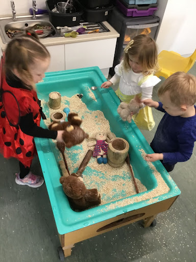 A photo of Hundred of Hoo Nursery pupils wearing their fancy dress outfits for World Book Day 2022 and playing in the sand pit.