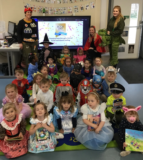 A photo of Hundred of Hoo Nursery pupils wearing their fancy dress outfits for World Book Day 2022 and posing for the camera.