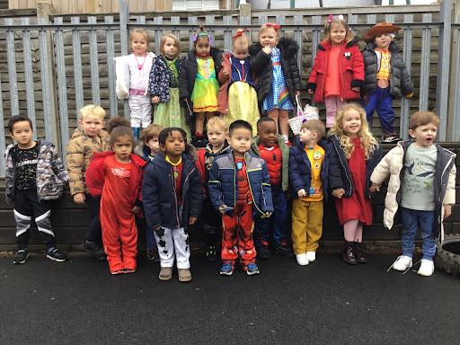 A photo of Hundred of Hoo Nursery pupils wearing their fancy dress outfits for World Book Day 2022 and posing for the camera.